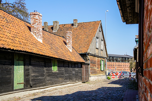 View of Liepaja old town with ancient wooden houses with clay tile roofs, many chimneys