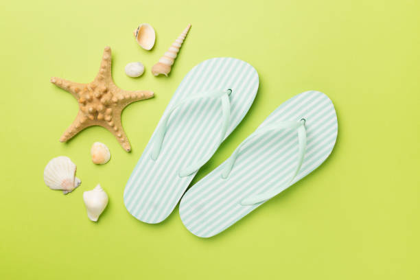 istock Striped flip flops on color background, top view 1492691760