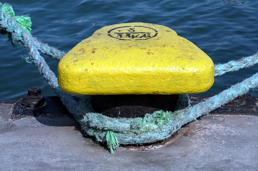 Yellow mooring bollard at the port