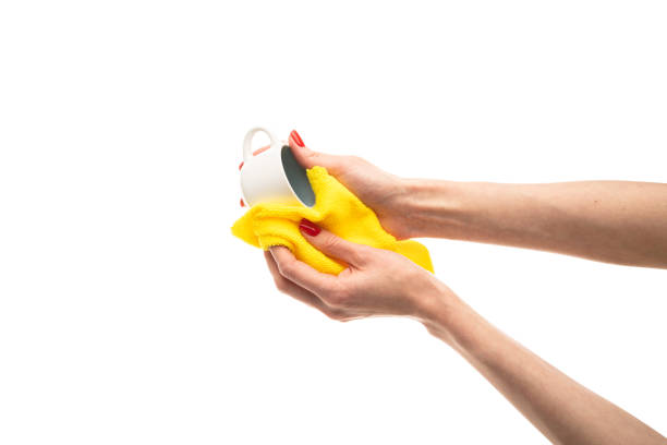 istock Woman wiping white cup with towel in kitchen, closeup 1492695772