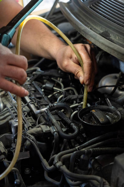 istock selective focus, detail of a mechanic's hand vacuuming a car engine 1492697228
