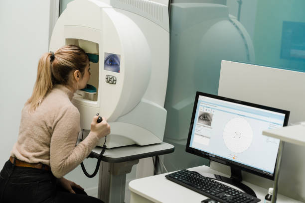 istock Perimetry visual field test for measure all areas of eyesight, including side, or peripheral vision. Perimetry eyes test for early sign of glaucoma of woman patient of ophthalmology clinic. 1492698482