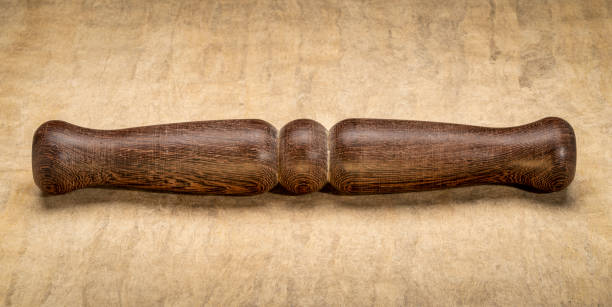Wooden Tai Chi ruler, a  traditional Chinese exercise tool, rests on textured paper, symbolizing tranquility and balance. Perfect for wellness and mindfulness themes.
