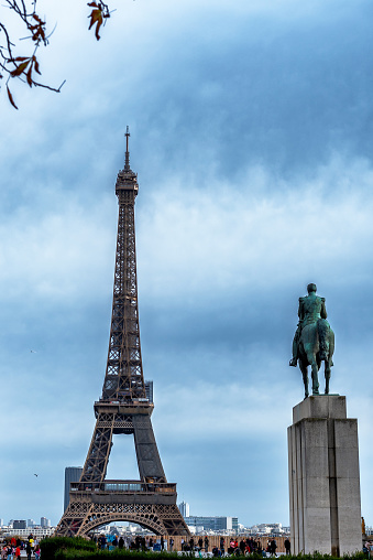 Scene at Trocadero Square with the world famous Eiffel Tower in the background as seen from Trocadero Square on a partially cloudy day