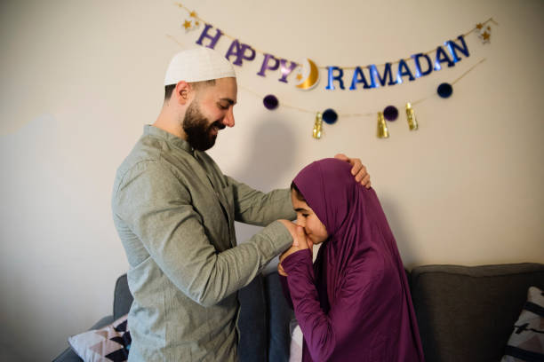 istock North-american muslim father and daughter praying at Ramadan. 1492704792