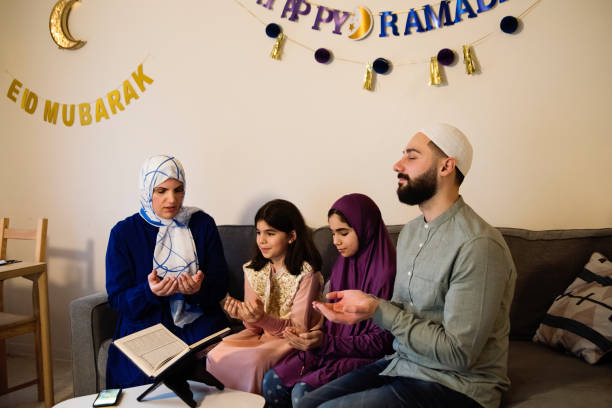 istock North-american muslim family praying before Iftar at Ramadan. 1492704976