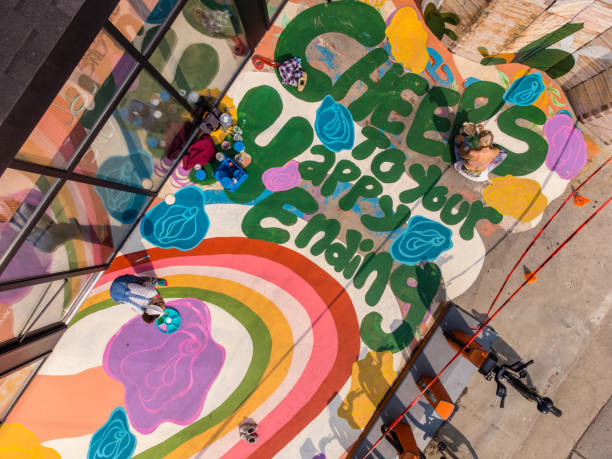 istock Two Female artists painting large sidewalk mural 1492714700