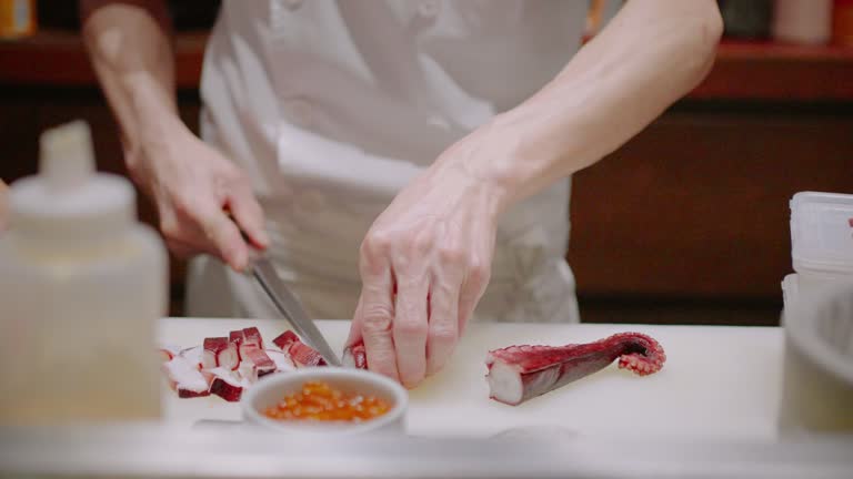 Japanese chef slice Tako or Octopus for cooking at Japanese restaurant