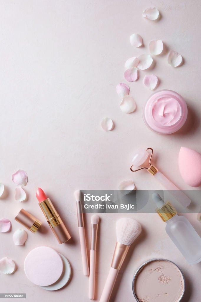 Pastel make-up equipments Pastel make-up equipments with pink rose petals Face Serum Stock Photo