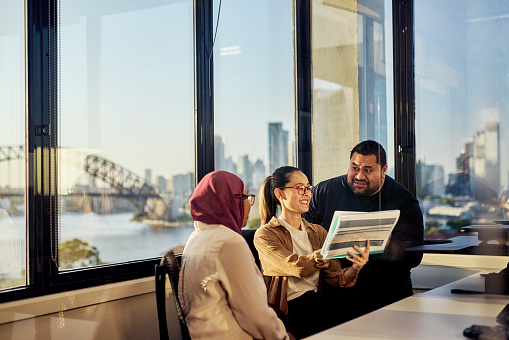 Colleagues from diverse backgrounds working together harmoniously in an Australian office.