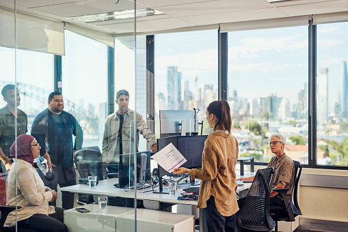 Teamwork and collaboration in a tech-driven Australian office with stunning Sydney views.