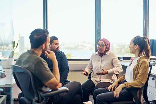 Colleague who is offering support to her fellow office workers