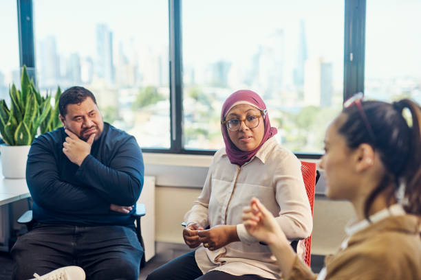 istock Indonesian-Australian woman talking with participants in a group therapy session 1492720225