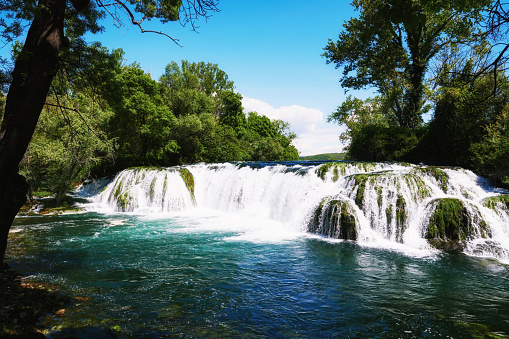 Famous Kocusa waterfall in Bosnia and Herzegovina. Wide streaming water falling from the rock