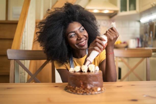 istock A smiling woman holding an icing bag over a cake 1492720432