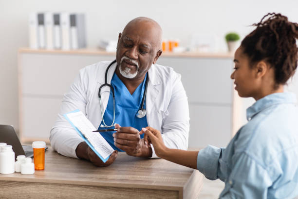 istock Mature black doctor explaining treatment plan to female patient 1492721793