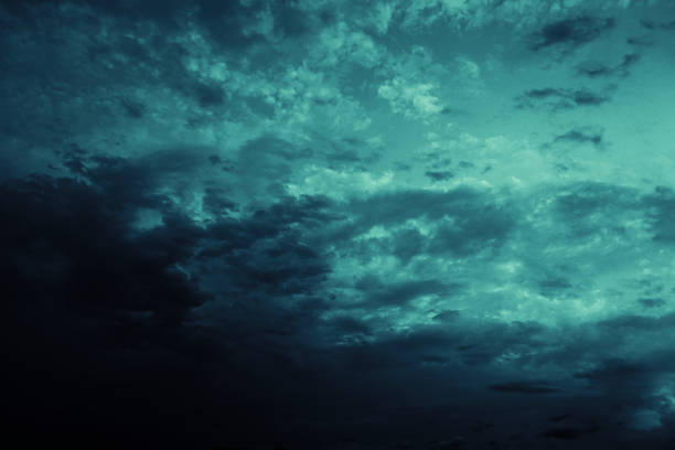 Black blue green teal night sky with clouds. Storm, wind, rain. Dramatic dark skies background. Glow, light, lightning. Magical, mystical, ominous, frightening, spooky, fantasy, fantastic heaven.