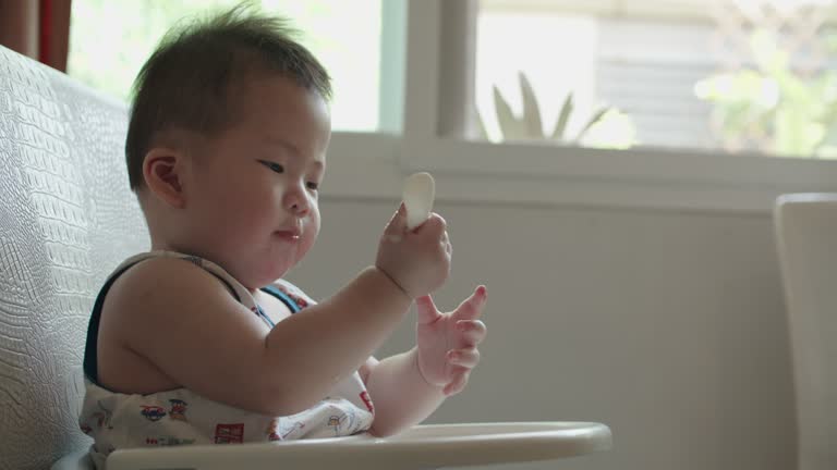 Baby holding toy for bite