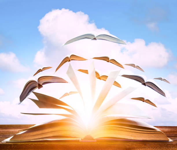 istock abstract realistic of paper book flying to cloudy sky ,knowledge conceptual 1492727934