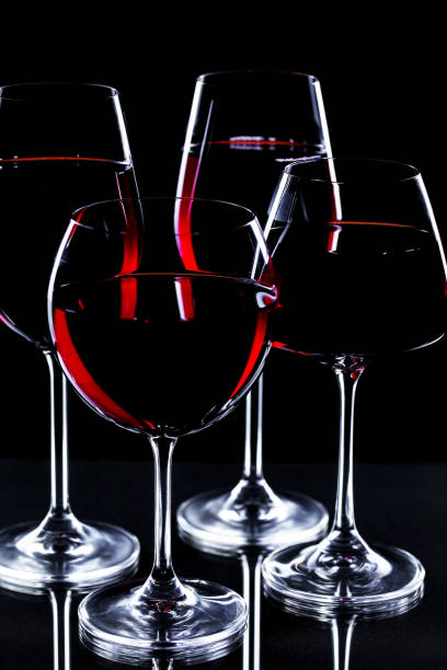 istock Glass with red wine on black background 1492730741