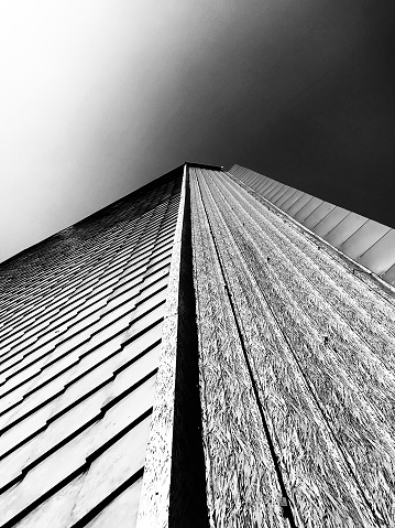 Beautiful exterior architectural features made from wood in a tall building headed up to the sky