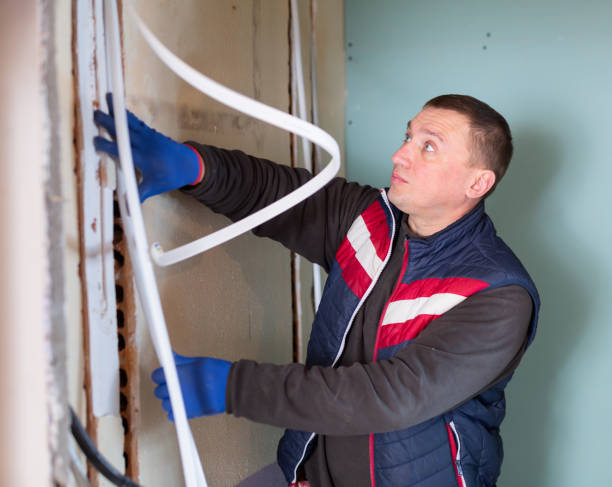 istock Electrician lying down cable duct during repair works 1492734531