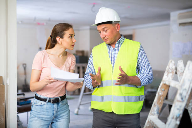 istock Apartment owner and builder discussing repair works plan 1492735261
