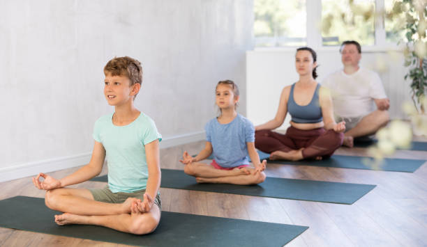 istock Family with two children doing yoga in studio 1492736341