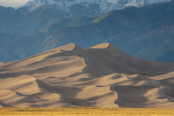 istock Star Dune Rises From The Valley Floor With Mountains In The Distance 1492745992