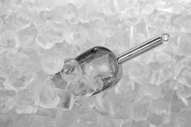 Ice scoop with ice cubes Close up stainless ice scoop with ice cubes in bucket top view use for food and beverage background ice machines stock pictures, royalty-free photos & images