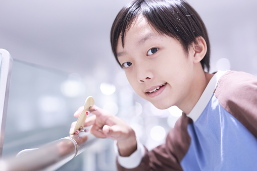 Boy is playing with his finger skateboard