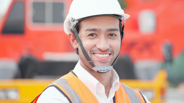 istock Asian engineer or manager of real estate construction projects or contractor have leadership and expertise wearing safety vest and helmet, standing at construction site of buildings or housing projects, smiling proudly, crossed arm and looking at camera. 1492764631