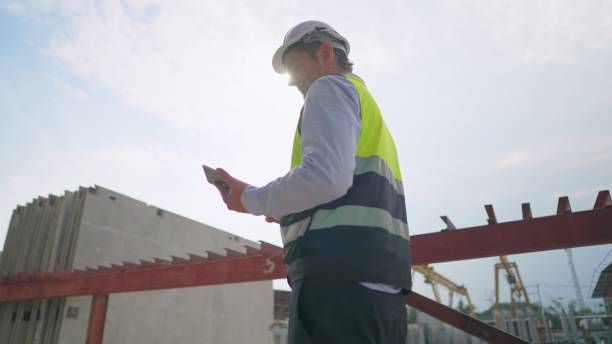 istock Engineer wearing safety uniform, inspect quality and production process of making precast concrete for build a house in production line of manufacturing.Male contractor working in factory. Employee or worker is working in real estate construction industry 1492764673