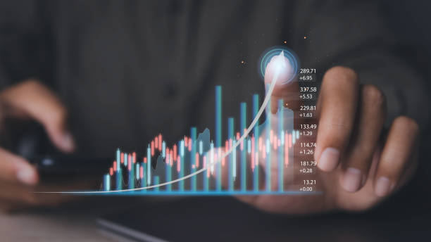 istock Stock market graph with man working on computer stock trading screen. 1492769171
