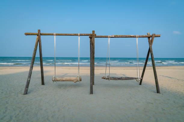 istock Swing made of wood and timber on the beach. 1492769721