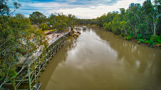 Echuca, Victoria, Australia - 12 August 2022: Overhead the Murray River as a cruise boat approaches the Port of Echuca in Victoria