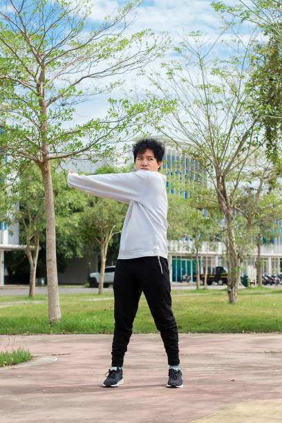 istock indonesian young men doing stretching exercise at city park 1492776468