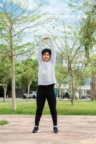 istock indonesian young men doing stretching exercise at city park 1492776479