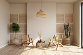 Living Room Interior With Wicker Armchairs, Potted Plants And Coffee Table