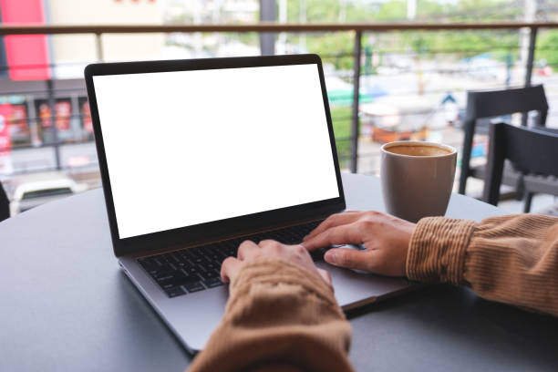 istock Mockup image of a woman using and working on laptop computer with blank white desktop screen 1492778260