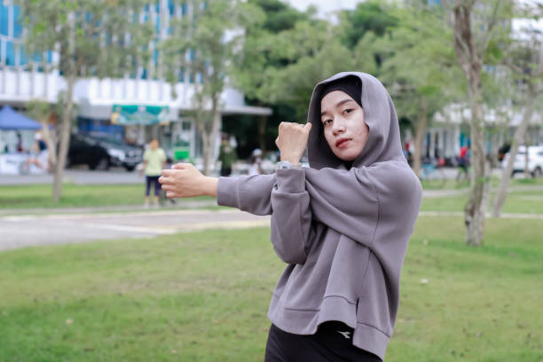 istock asian young muslim female excercise at park 1492780413