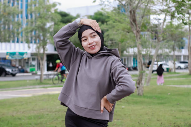 istock asian young muslim female excercise at park 1492780459