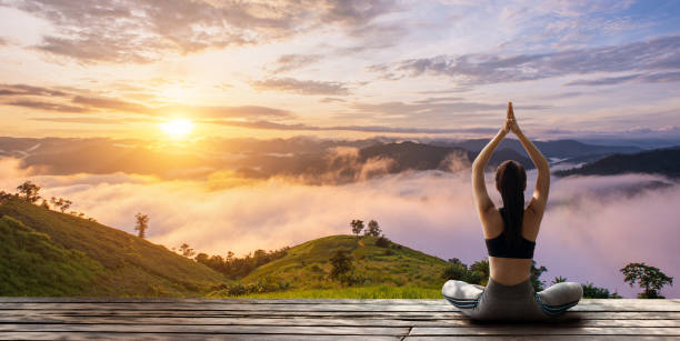 istock Young woman practicing yoga in the nature 1492782165