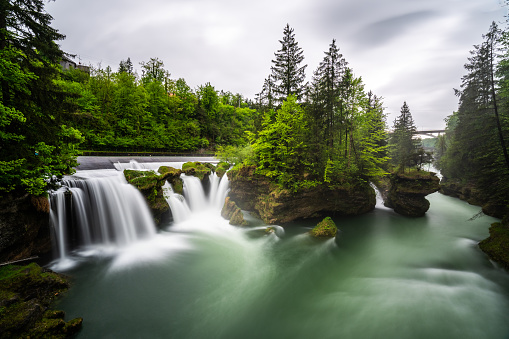 Blurred waterfall series: manmade waterfall Traunfall wide shot.