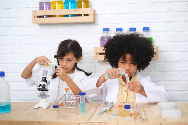 istock Children doing chemical experiments in school laboratories, science students, experiment, observation and curiosity concept. The first step of becoming a scientist 1492782299