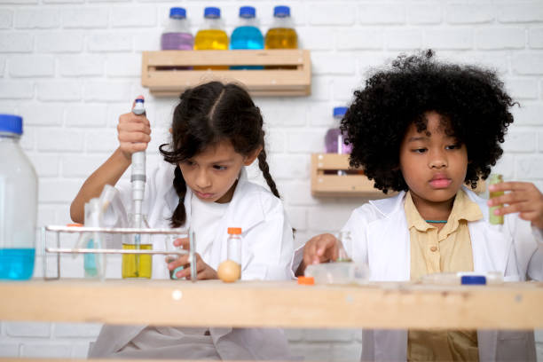 istock Children doing chemical experiments in school laboratories, science students, experiment, observation and curiosity concept. The first step of becoming a scientist 1492782324