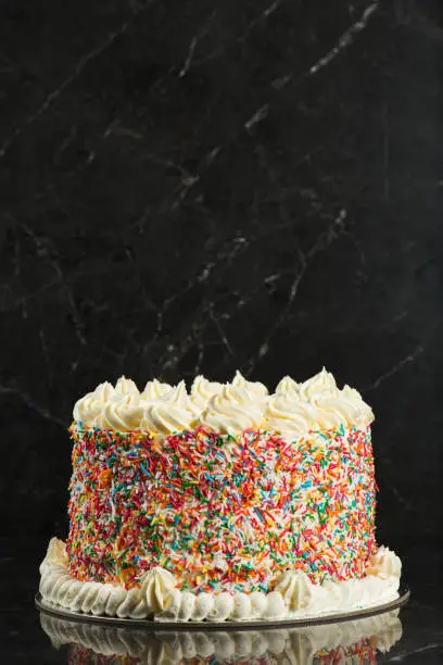 Delicious birthday-themed butter cake with buttercream icing and rainbow sprinkles