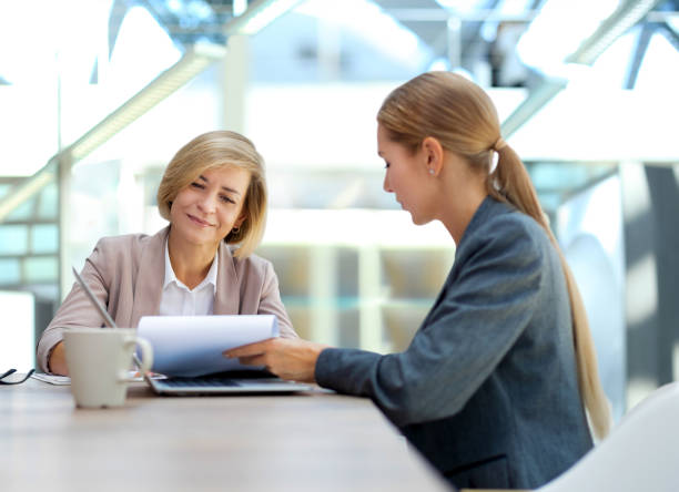 istock Image of two business women working in the office with documents. 1492788660