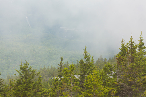 Mountain fog lifting out of the valley, seen from the summit of Mt. Kearsarge in Wilmot, New Hampshire.