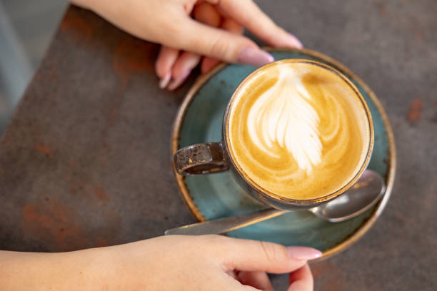istock Woman is holding a cup of coffee 1492793082